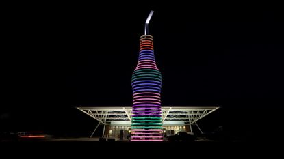 A giant soda sculpture is illuminated in front of Pops 66 in Oklahoma