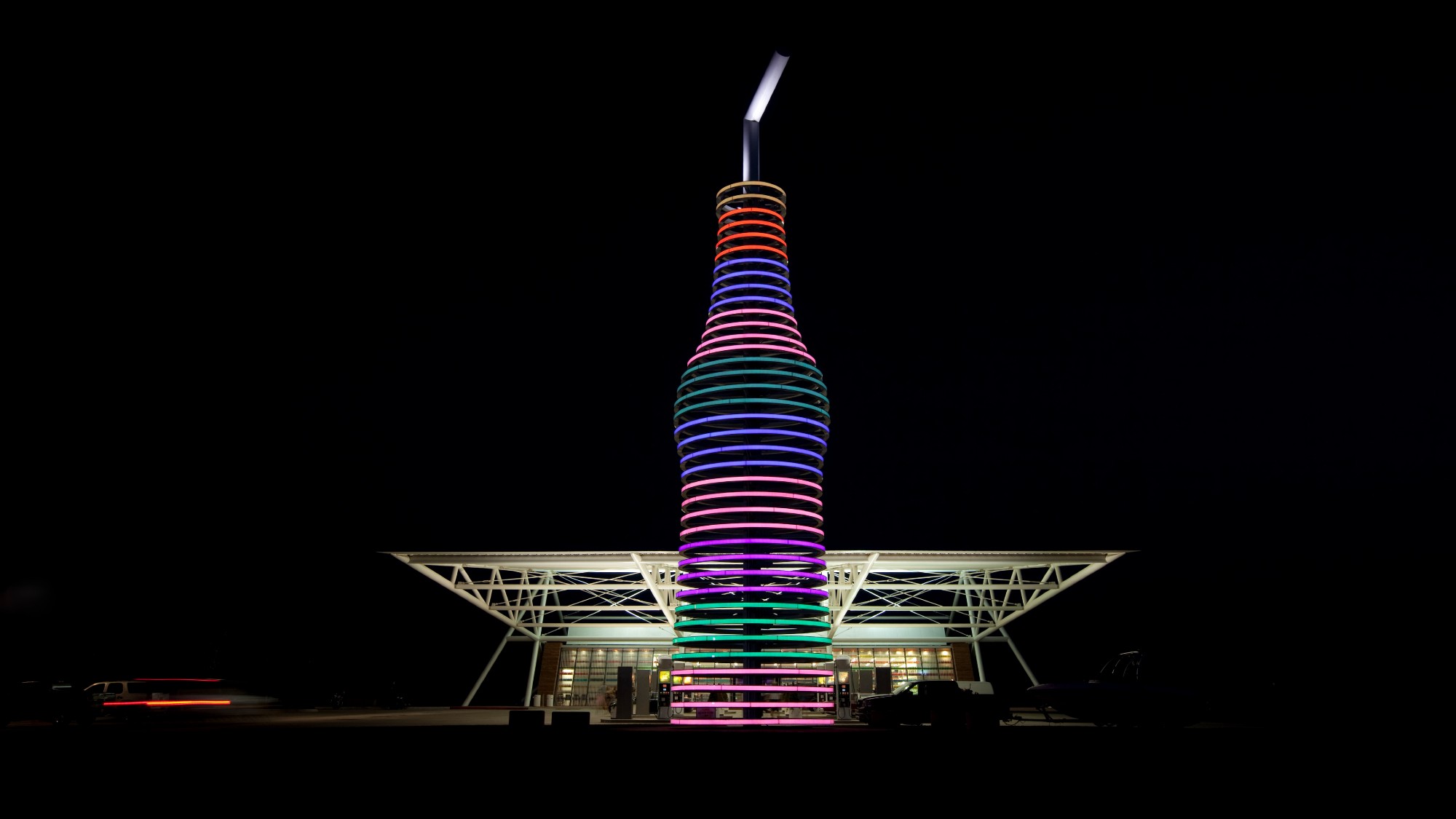 A giant soda sculpture is illuminated in front of Pops 66 in Oklahoma