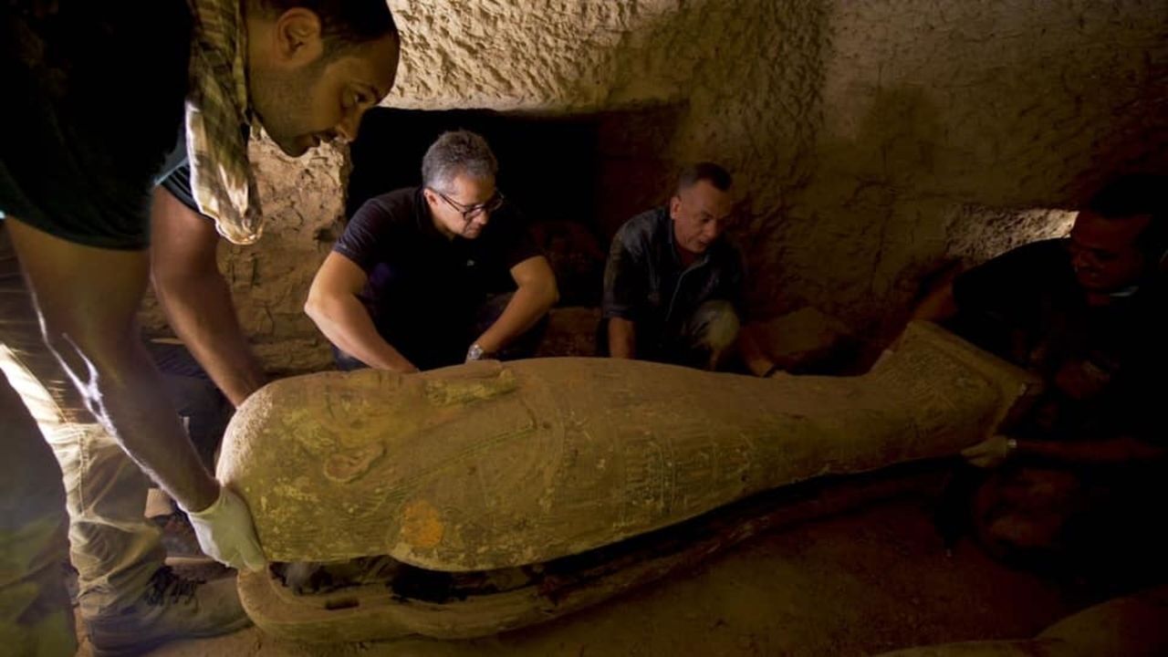 The excavation team assesses one of the coffins.