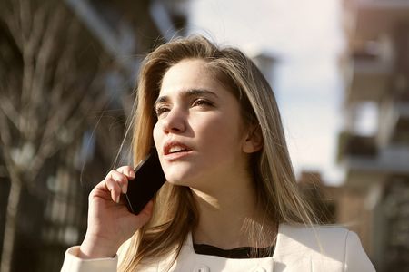 Young woman with smartphone outside