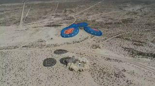 Blue Origin's RSS First Step crew capsule lands under parachutes in West Texas after launching on an uncrewed suborbital test flight from the company's nearby Launch Site One on April 14, 2021.