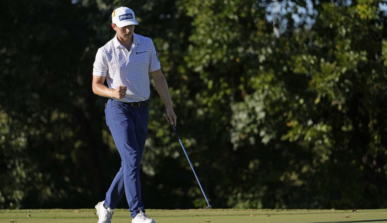 Hughes fist pumps after holing a putt