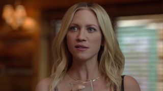 Brittany Snow as Sophie holding a glass in The Hunting Wives