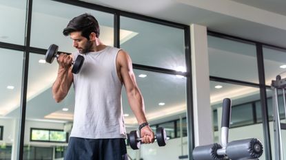 Man performing dumbbell curls