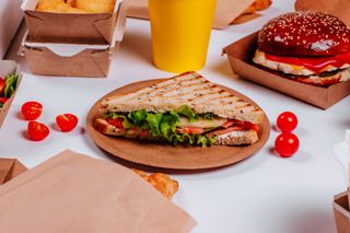 A sandwich and burger on a table.