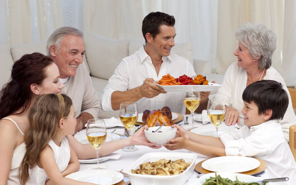 A family gathers around the dinner table