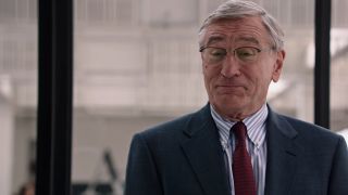 Robert De Niro wearing glasses and a suit in The Intern