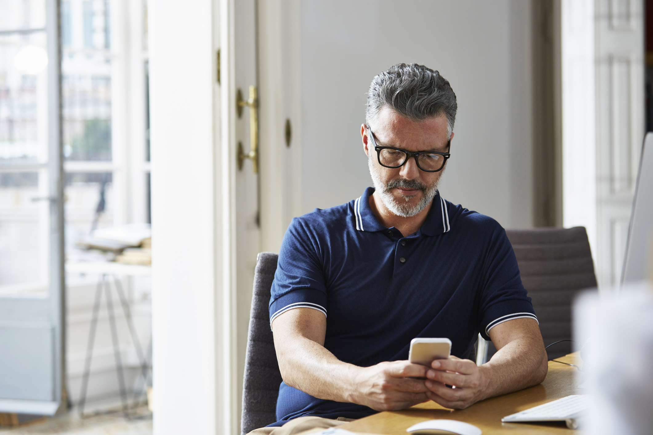 Businessman using mobile phone at desk