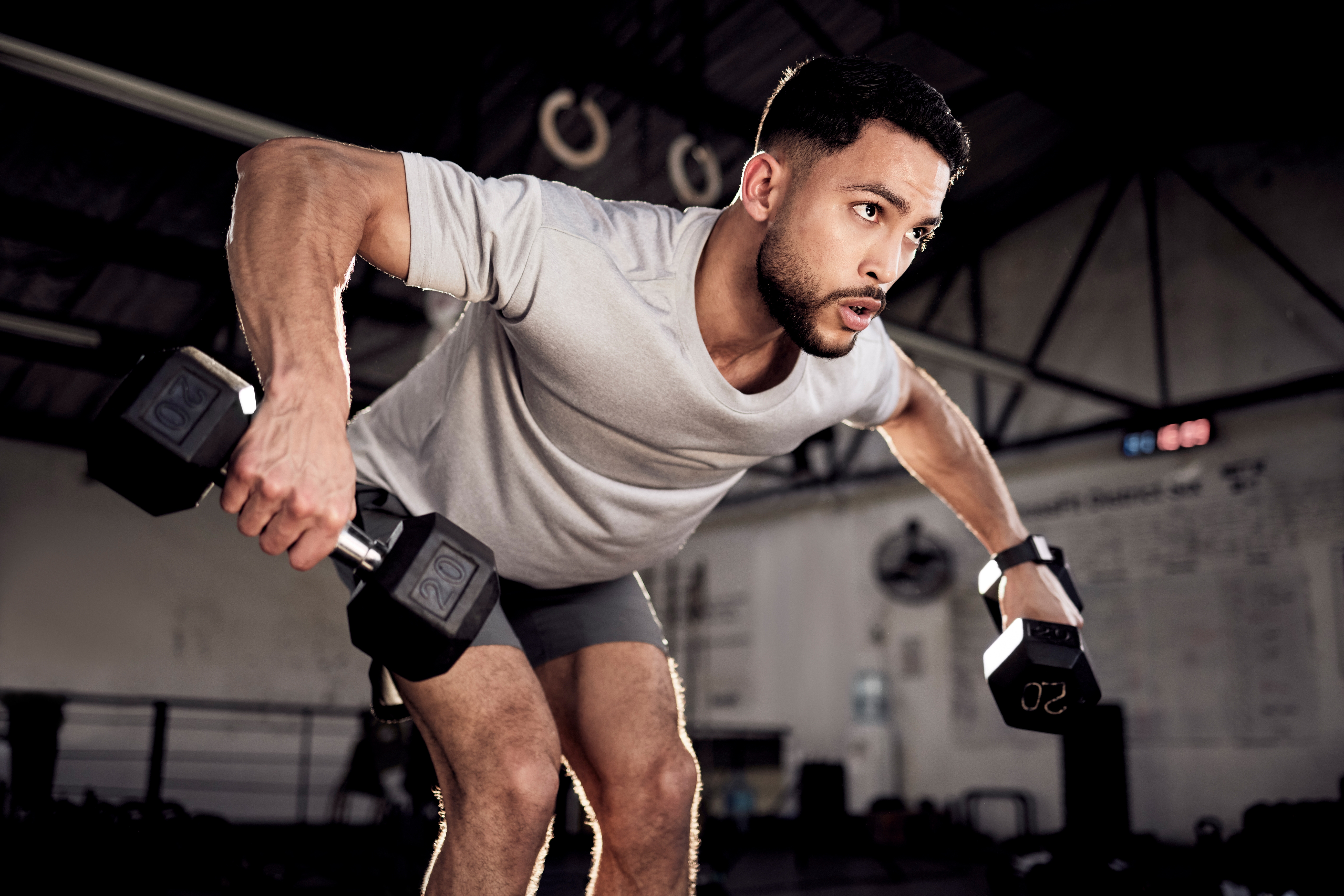 a man doing a dumbbell bent-over reverse fly