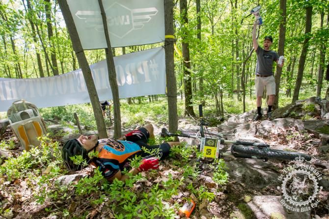 David Cook falls on the rock garden on the final singletrack section of Stage 7