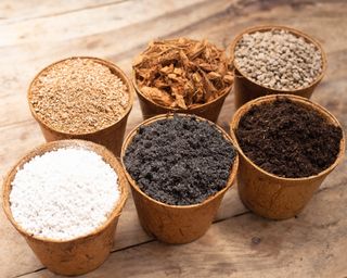 Various ingredients for making seed-starting mix in small pots