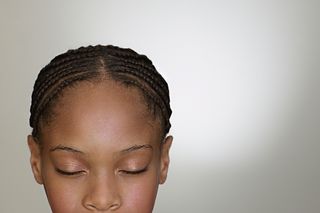 A girl wearing cornrow braids.