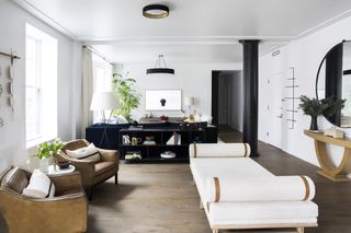 A living room with a white daybed next to the entrance