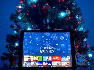 Disney+ Holiday movies on iPad Pro in front of Christmas tree