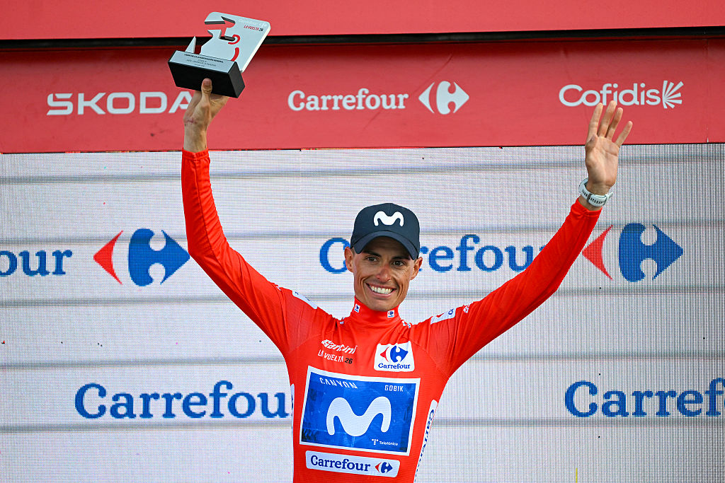 Overall race leader Team Movistar's Spanish rider Enric Mas celebrates retaining the race lead on the podium after the 14th stage of the Vuelta a Espana 2026 cycling tour, a 154,5 km race between Jaen and Sierra de la Pandera, on September 5, 2026. (Photo by JORGE GUERRERO / AFP)