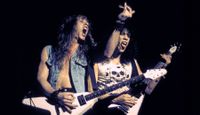 James Hetfield and Kirk Hammett performing live onstage, playing Gibson Flying V guitars, February 11, 1984 