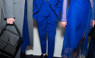 Idea of the power suit, making it bold, courageous and gutsy. A long, black puffer jacket with a block of Yves Klein blue, styled with a chain link belt was a refreshing departure from the oversized style