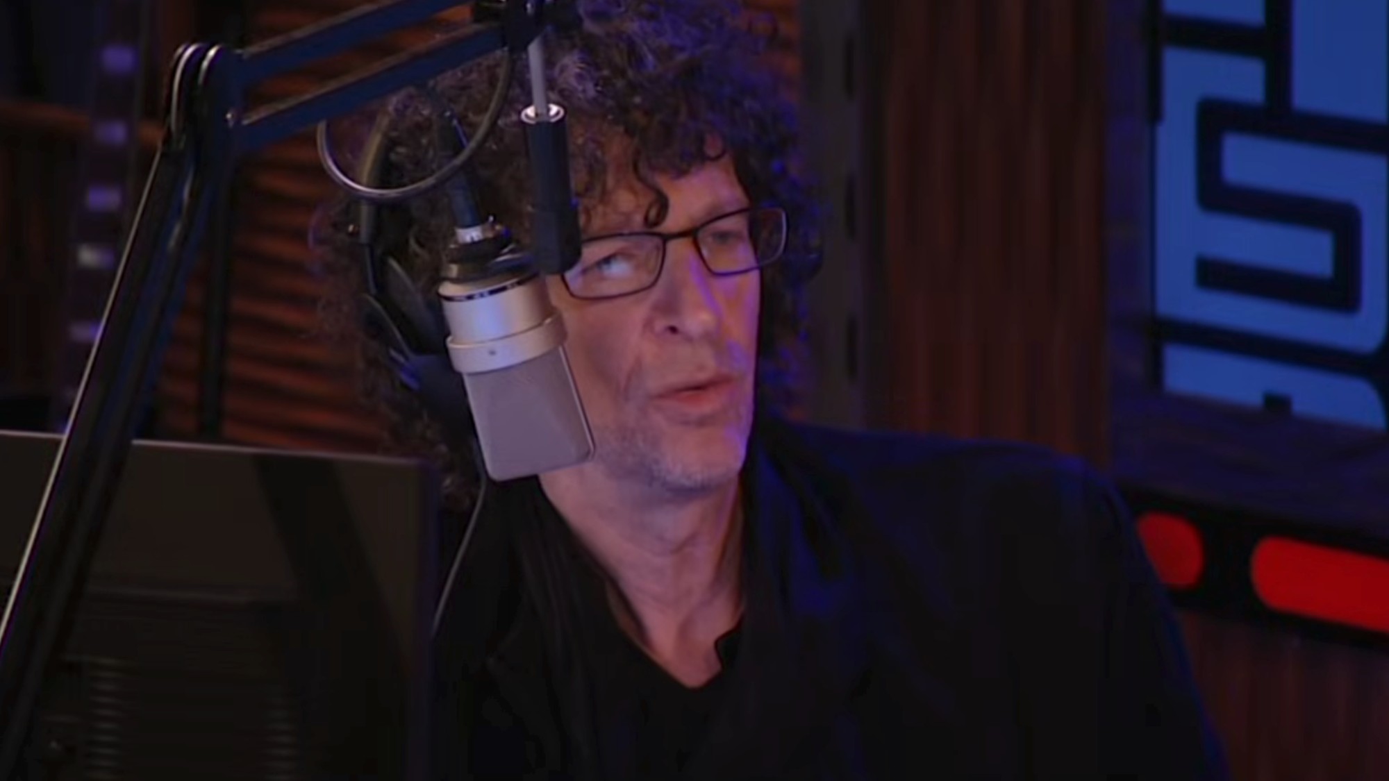 Howard Stern talking into a radio microphone on The Howard Stern Show