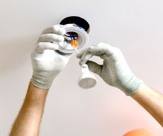 LED downlight being fitted into ceiling