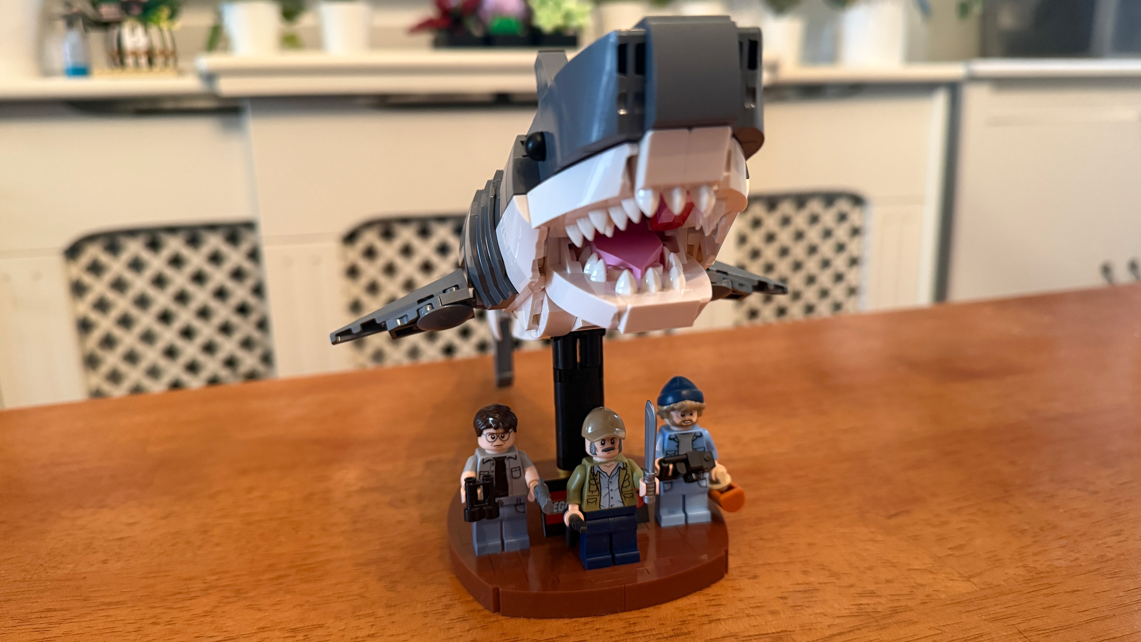 A close up of Bruce on display stand and the three minifigs from Lego Jaws (21350)