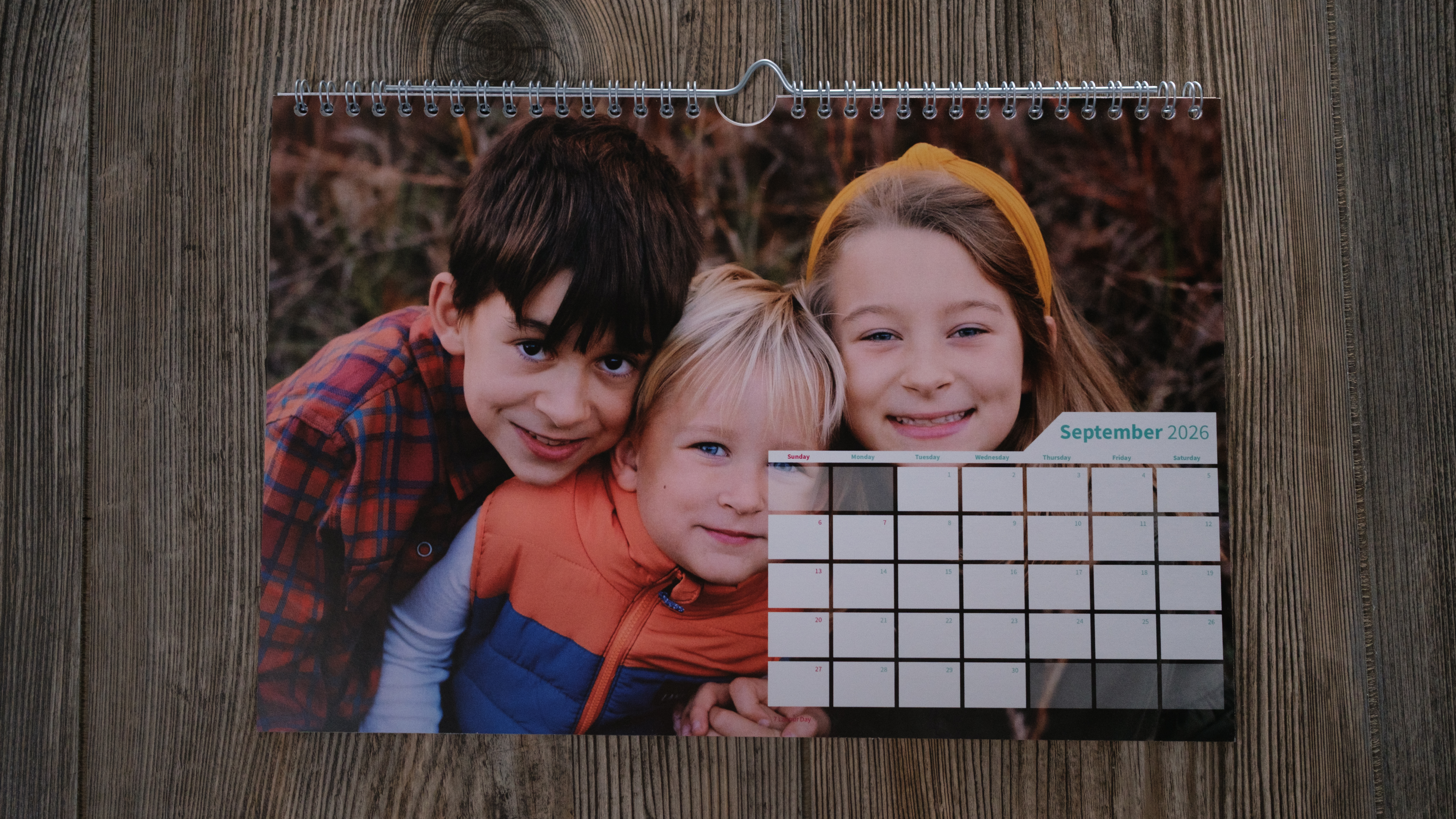 A wall calendar from Saal on a wood background