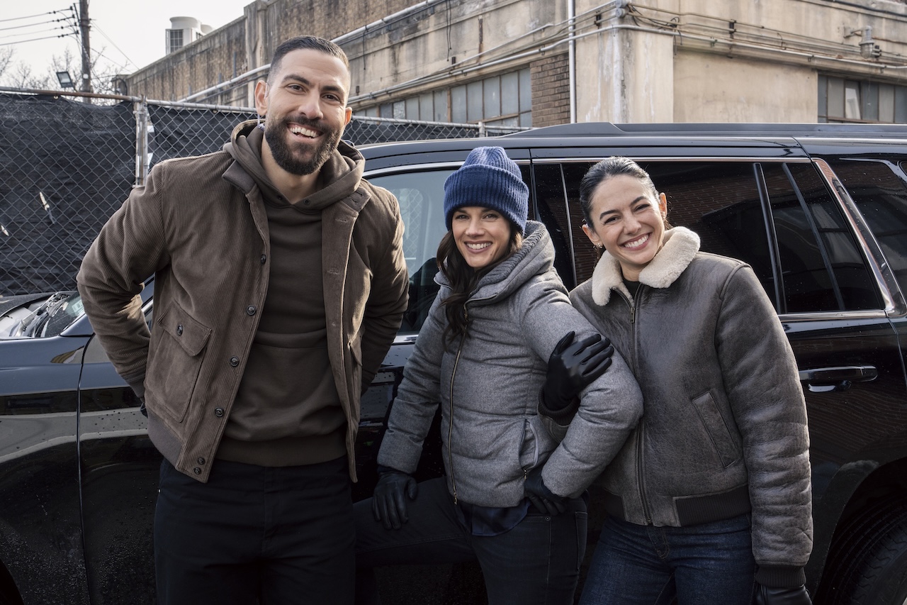Zeeko Zaki, Missy Peregrym, and Pardis Saremi smiling behind the scenes during production on CBS' FBI Season 8x17 first look-sized photo