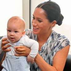 Meghan Markle holding baby Prince Archie and smiling