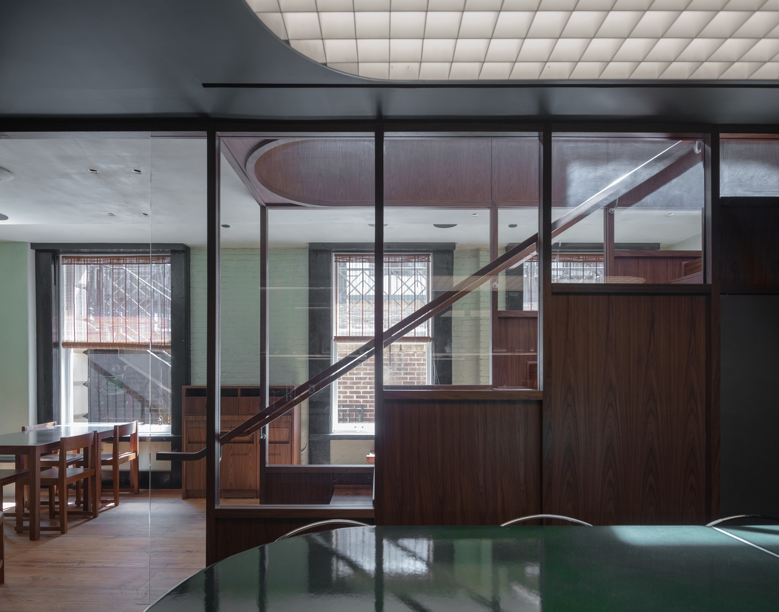 A futuristic matcha cafe features Japandi interiors punctuated by wood, chrome, or emerald green tones, and a sci-fi-esque bar setup with dripping water bottles and lights.