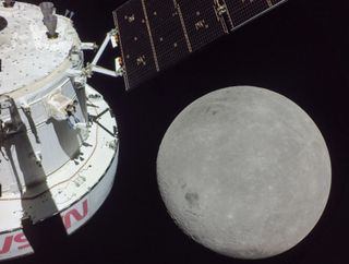 the backend of a spacecraft sits in frame with the moon, approaching.