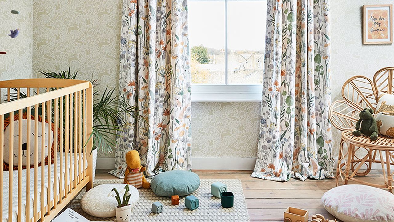 Nursery with wooden furniture and patterned curtains