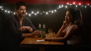 Tom Ellis as Nick and Gina Rodriguez as Mack having dinner in Players