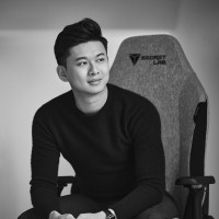 Ian Ang, Secretlab's CEO, sat on a gaming chair in black and white.