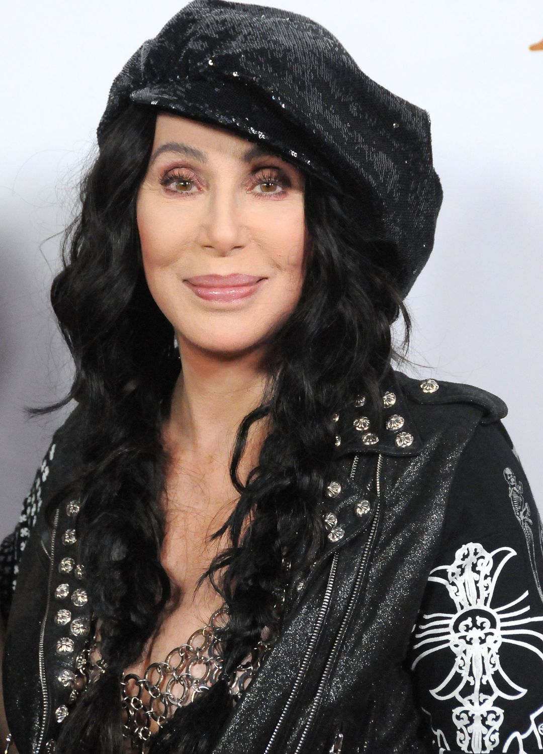 Cher wearing a sequin black beret