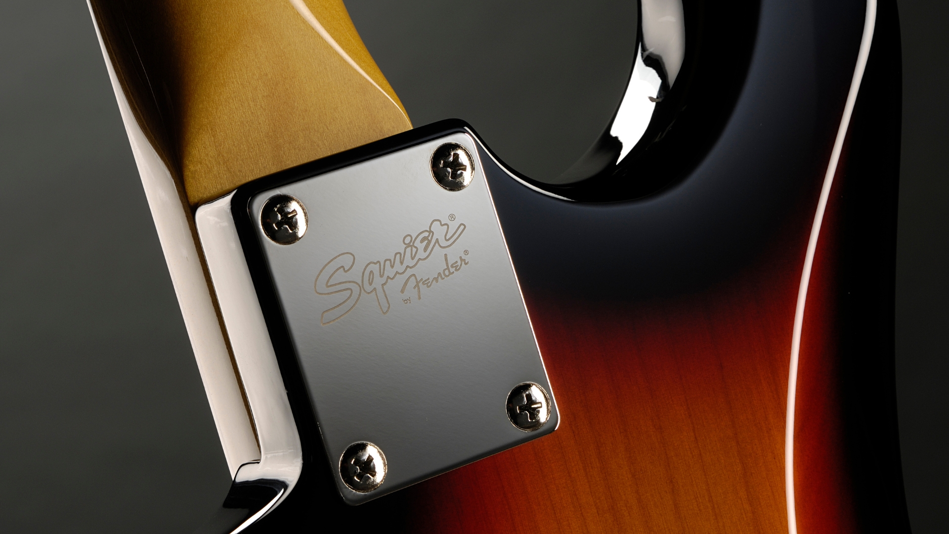 Close up of the neck plate on a Squier Stratocaster electric guitar