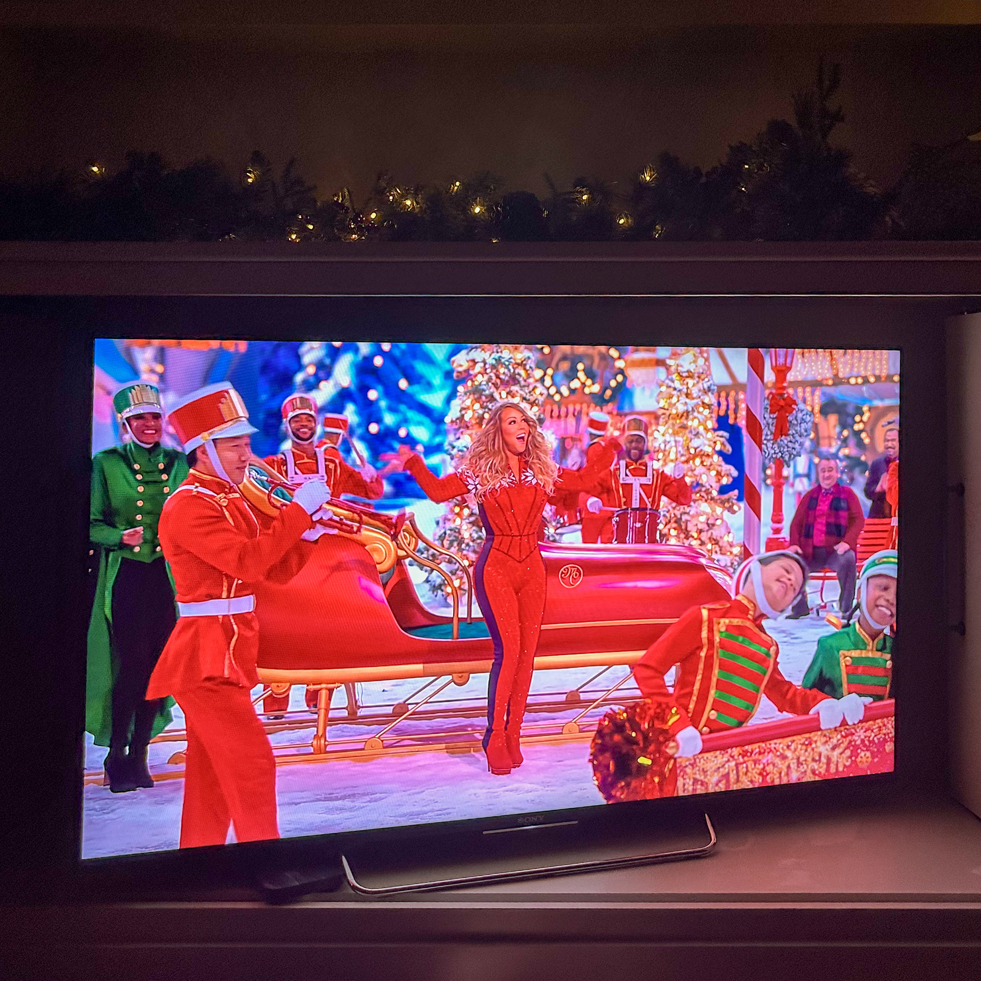 television showing mariah carey perform in christmas outfit