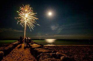 Fireworks with the moon in the background