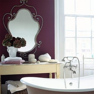 bathroom with purple wall and bathtub