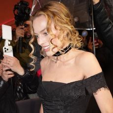 Margot Robbie traded her custom Chanel ballgown for a corseted little black dress and a matching choker necklace