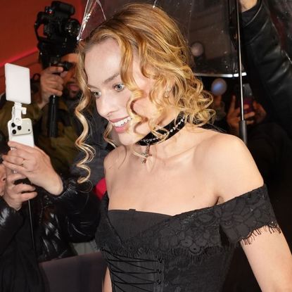 Margot Robbie traded her custom Chanel ballgown for a corseted little black dress and a matching choker necklace