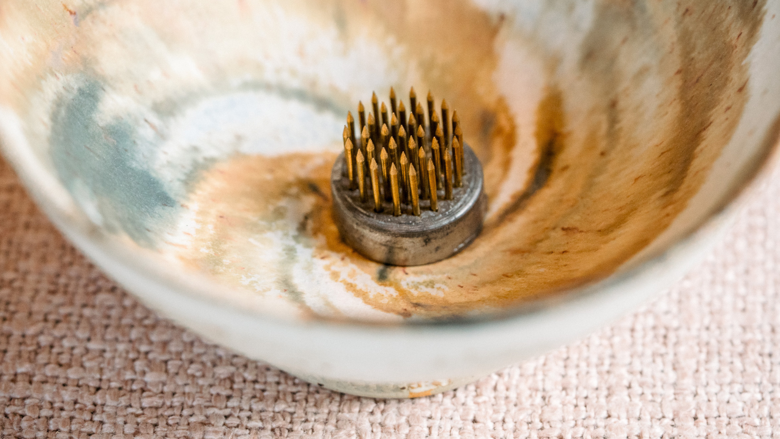 Close up of florist pin frog in ceramic bowl