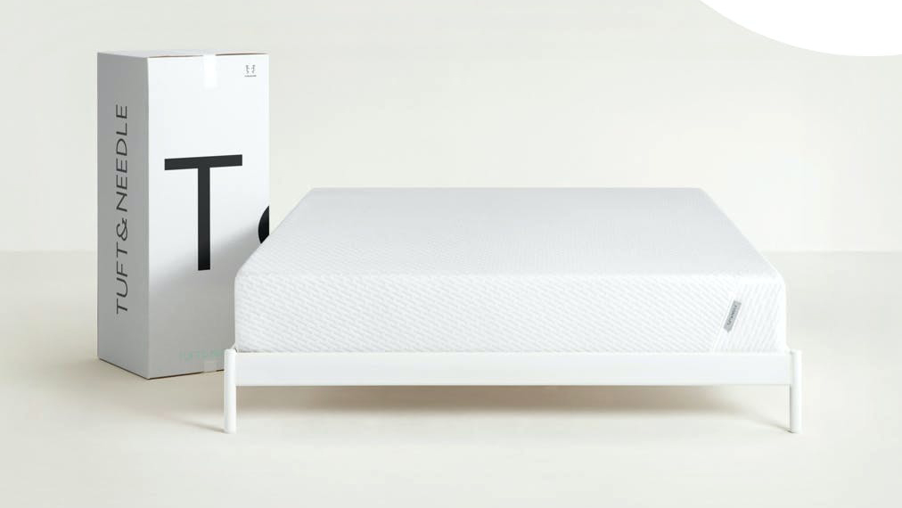 Best memory foam mattress: The Tuft and Needle Original Mattress sat on a white wooden bed frame