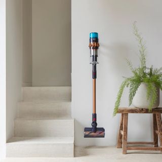 Dyson cordless vacuum hung on wall