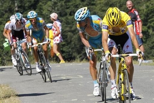 Alexander Vinokourov (Astana) looks back to check out the situation as Andy Schleck has a mechanical