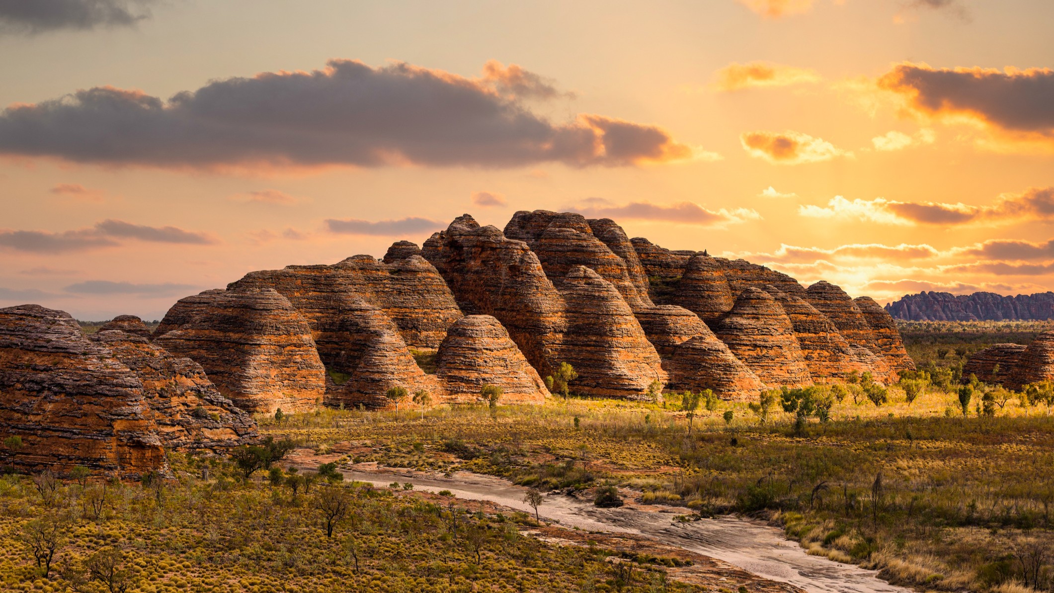 Bungle Bungle Range, Purnululu National Park, Kimberley Region, Western Australia, Australia. large rock formations against a beautiful sunset sky.