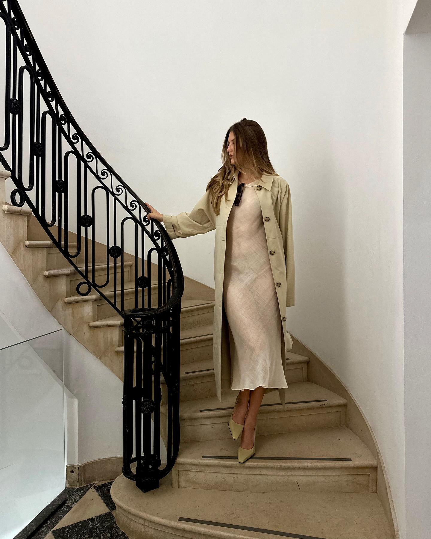 An image of @styledsara wearing a sheer white midi dress with pointed toe shoes.