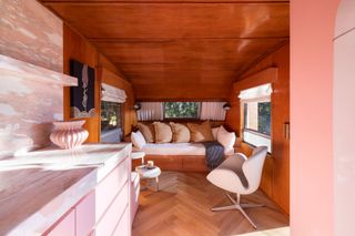 the living room in a converted trailer cabin