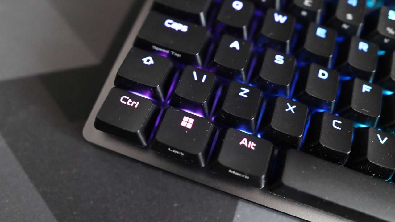 The Asus ROG Falchion Ace 75 HE on a desk with the lighting enabled.