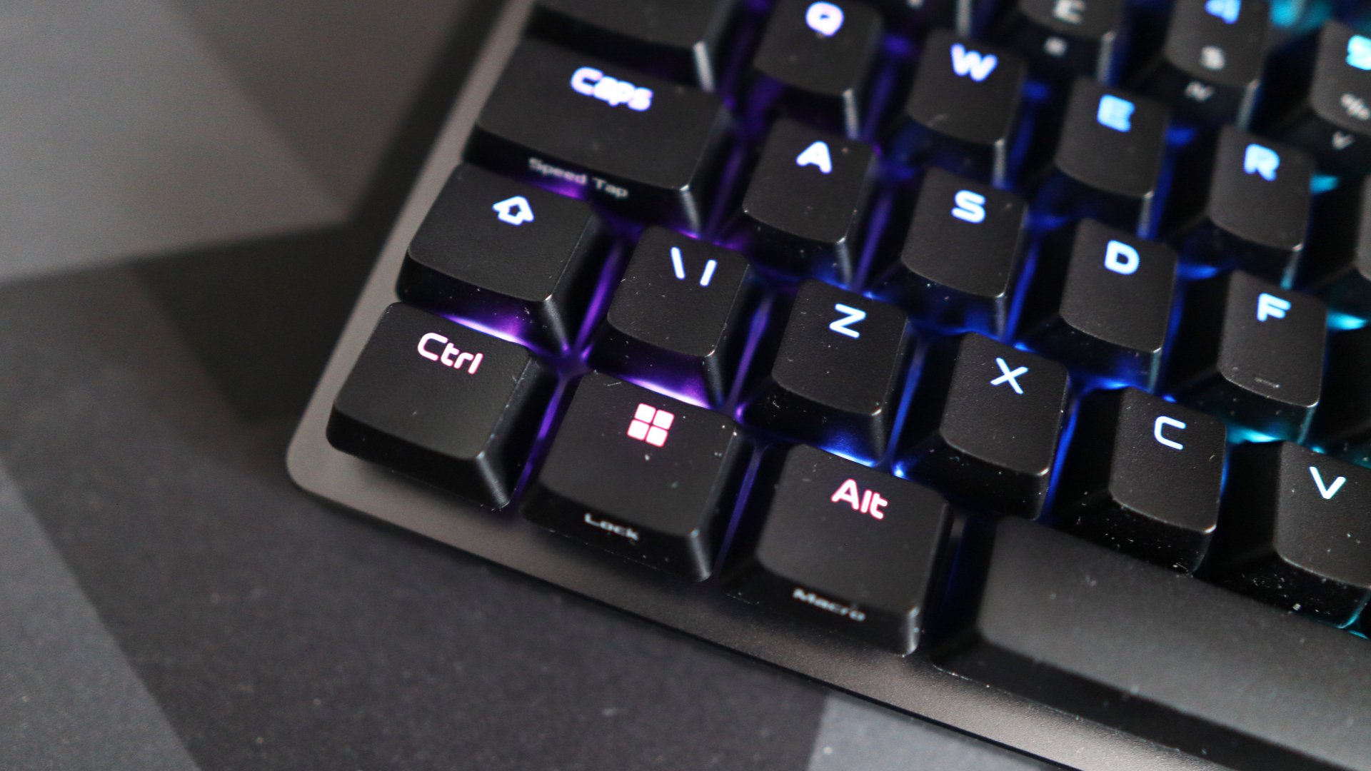 The Asus ROG Falchion Ace 75 HE on a desk with the lighting enabled.