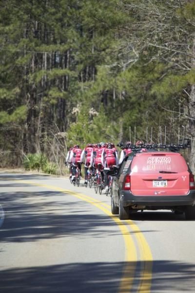 The Kenda Pro Cycling presented by Geargrinders team car follows its riders during a training camp.