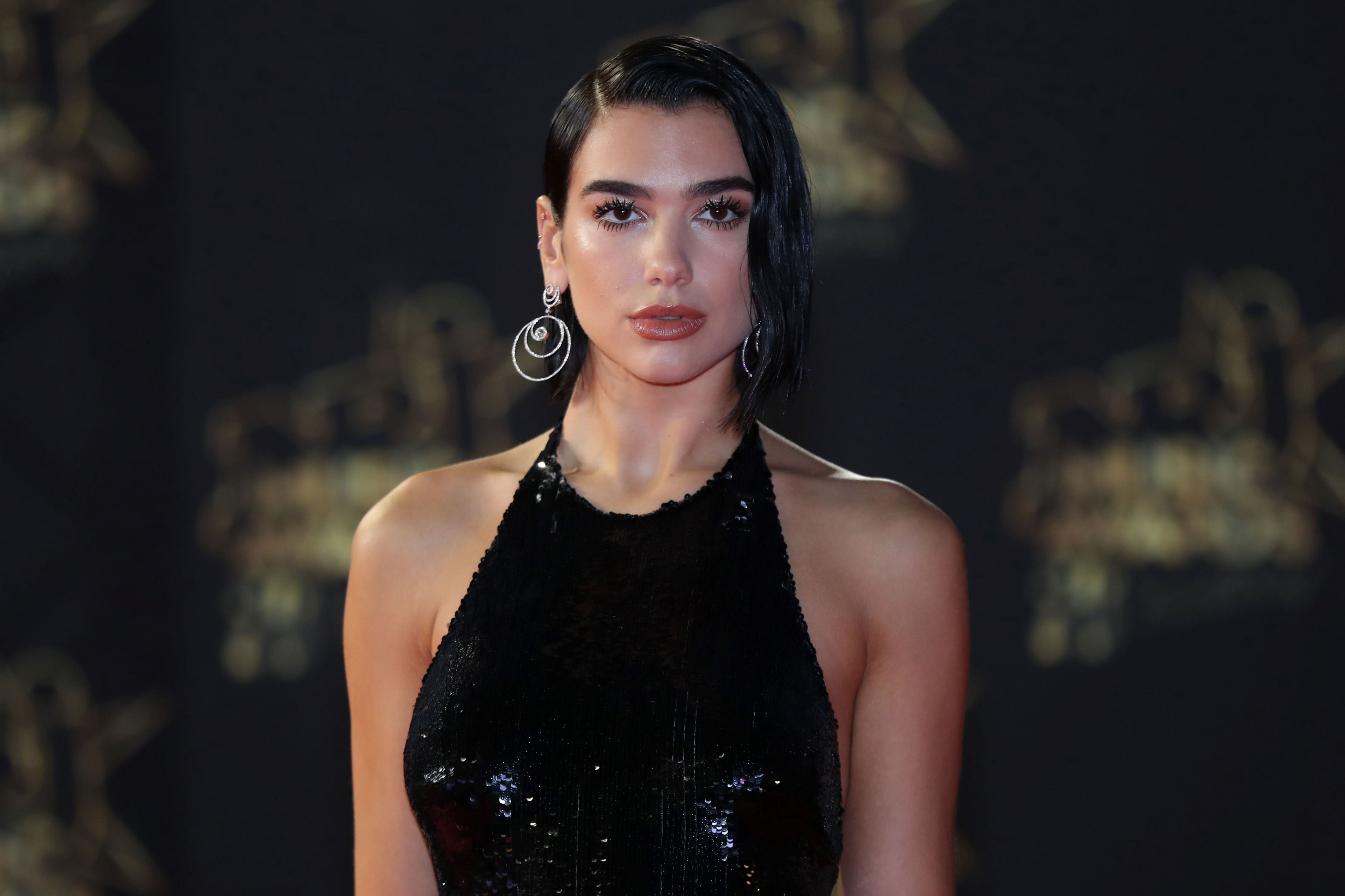 Dua Lipa in a black silk dress